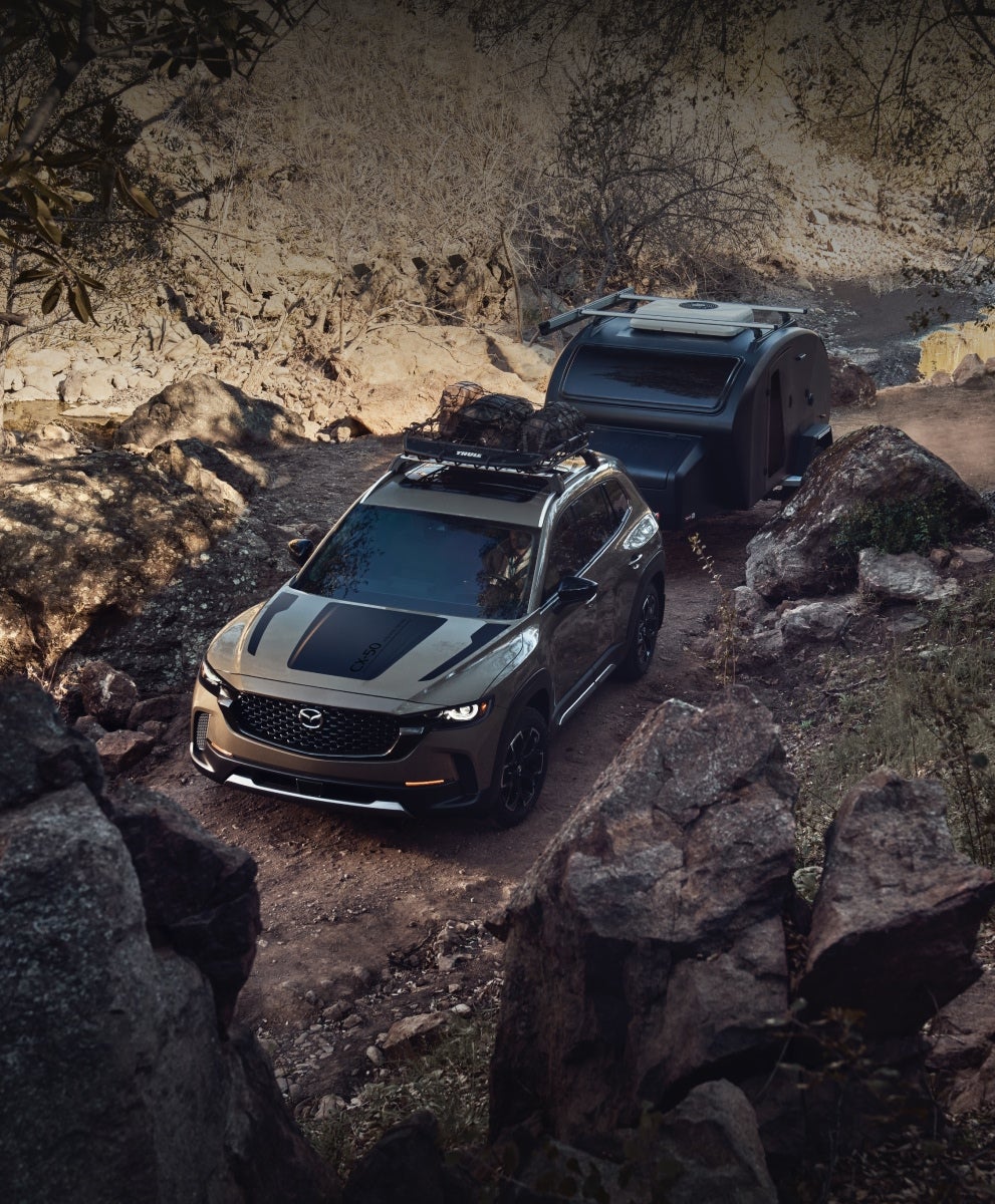 Two SUVs navigating a rocky off-road trail.